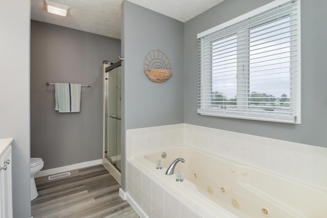 2738 Wharton Way, Normal, IL 61761 - full bathroom with toilet, a stall shower, a jetted tub, wood finished floors, and baseboards