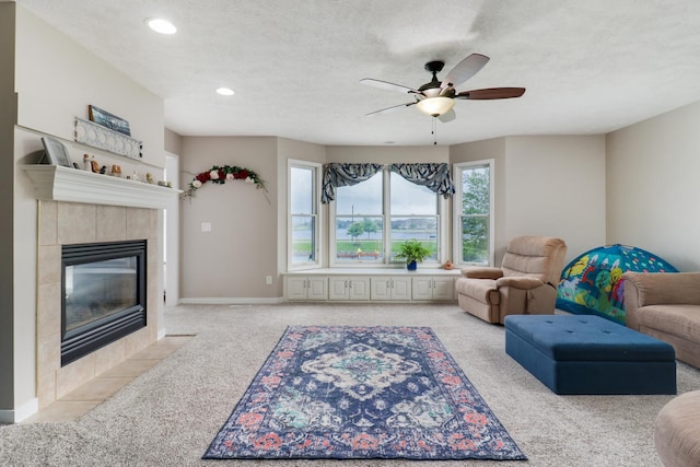 2738 Wharton Way, Normal, IL 61761 - living room with carpet flooring, a ceiling fan, a tiled fireplace, recessed lighting, and baseboards