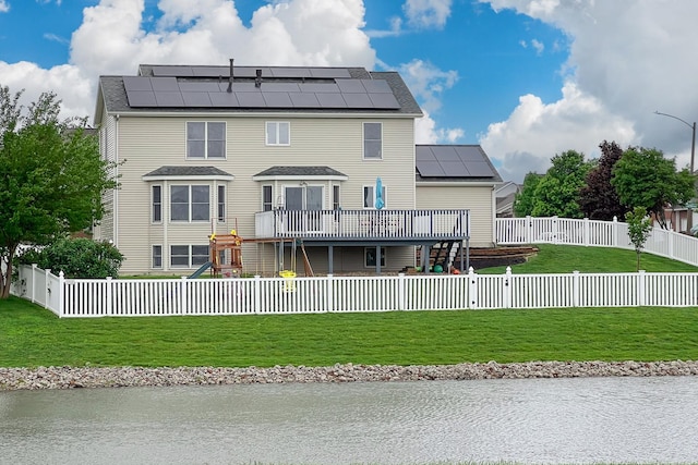 2738 Wharton Way, Normal, IL 61761 - rear view of house with a deck with water view, roof mounted solar panels, and a playground