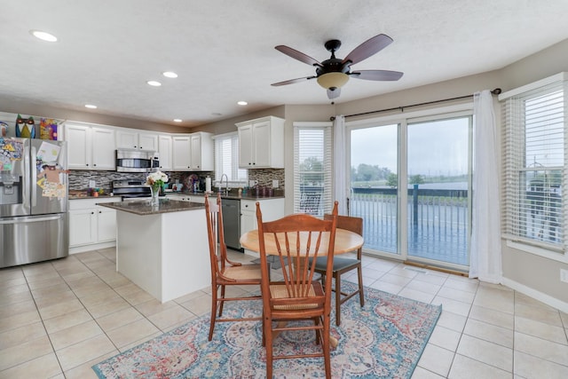 2738 Wharton Way, Normal, IL 61761 - kitchen featuring stainless steel appliances, backsplash, light tile patterned floors, a kitchen island, and recessed lighting