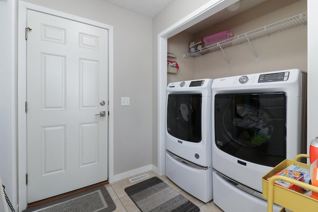 2738 Wharton Way, Normal, IL 61761 - laundry area featuring light tile patterned floors, baseboards, and washer and clothes dryer