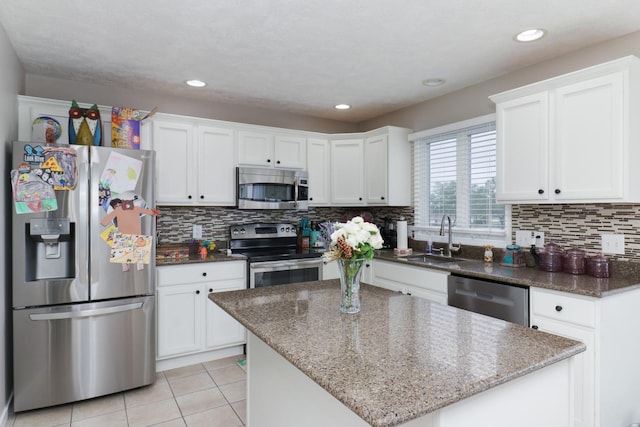 2738 Wharton Way, Normal, IL 61761 - kitchen with appliances with stainless steel finishes, a sink, white cabinetry, light tile patterned floors, and recessed lighting