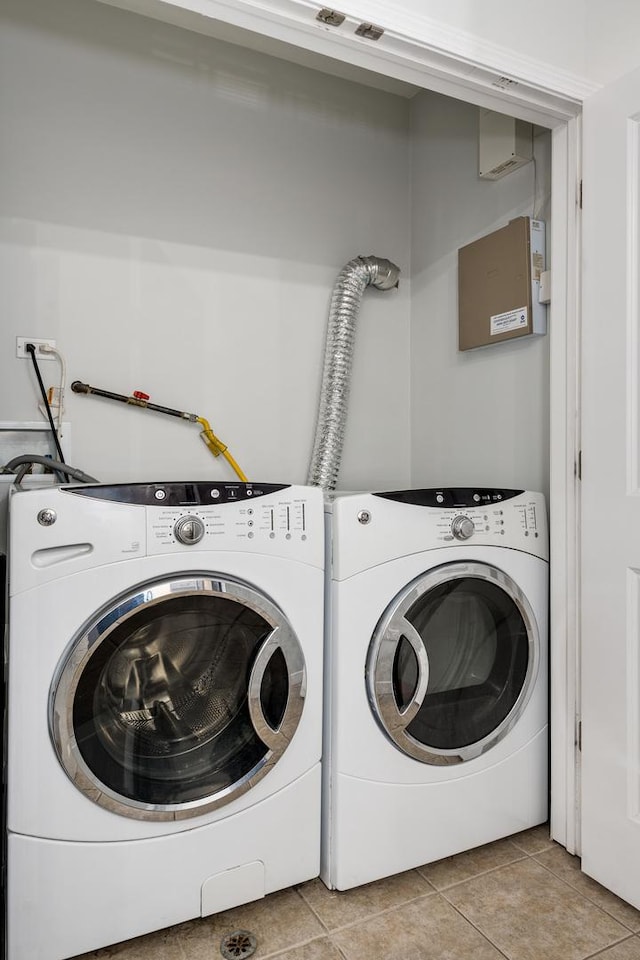 825 N Hudson Ave Unit 1B, Chicago, IL 60610 - laundry area with washer and dryer and light tile patterned floors