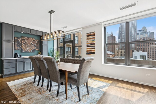 849 N Franklin St Unit 618, Chicago, IL 60610 - dining space with a view of skyline, dark wood-type flooring, and baseboards