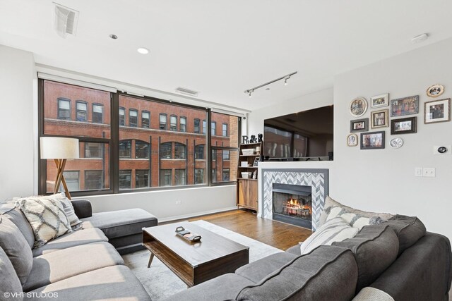 849 N Franklin St Unit 618, Chicago, IL 60610 - living room with wood finished floors, a tile fireplace, track lighting, and recessed lighting