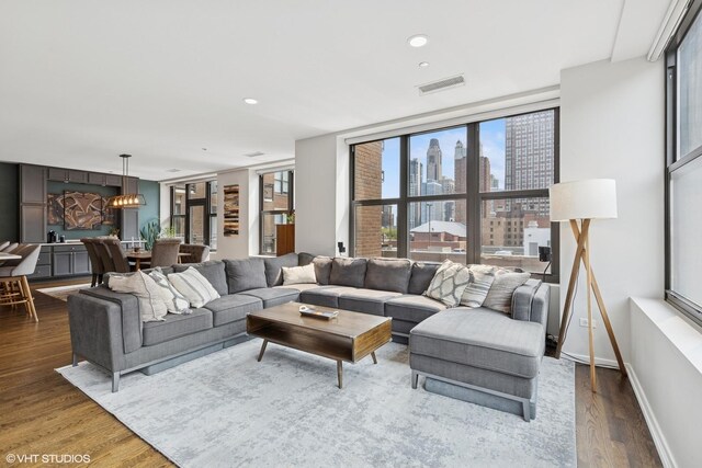 849 N Franklin St Unit 618, Chicago, IL 60610 - living room with wood finished floors, a view of skyline, baseboards, and recessed lighting