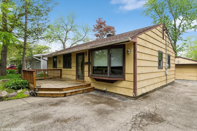 412 Midway Dr, Mundelein, IL 60060 - view of front of house with a deck, a garage, and an outbuilding