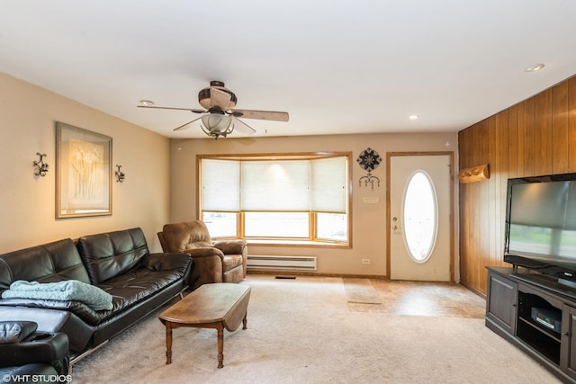 412 Midway Dr, Mundelein, IL 60060 - living room featuring a baseboard radiator, a ceiling fan, light carpet, and wood walls