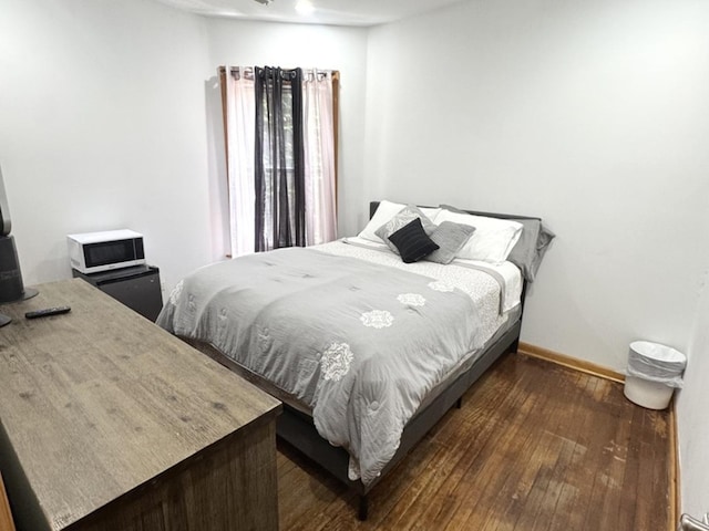 143 E 111th St, Chicago, IL 60628 - bedroom featuring dark wood-style floors and baseboards