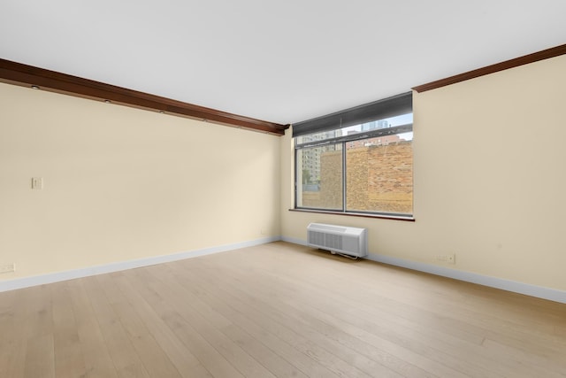 1450 N Astor St Unit 7D, Chicago, IL 60610 - empty room featuring ornamental molding, baseboards, a wall mounted air conditioner, and light wood-type flooring
