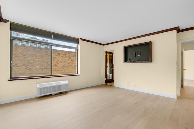 1450 N Astor St Unit 7D, Chicago, IL 60610 - spare room featuring crown molding, wood finished floors, baseboards, and a wall mounted air conditioner