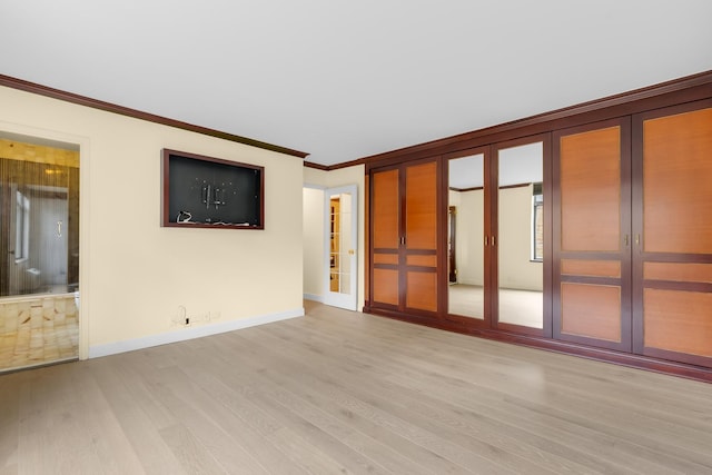1450 N Astor St Unit 7D, Chicago, IL 60610 - spare room featuring crown molding, light wood-type flooring, french doors, and baseboards