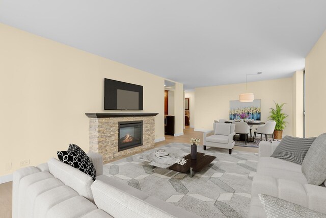1450 N Astor St Unit 7D, Chicago, IL 60610 - living area with a stone fireplace, light wood-style floors, and baseboards