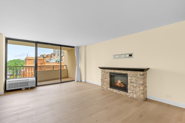 1450 N Astor St Unit 7D, Chicago, IL 60610 - unfurnished living room with wood finished floors, a fireplace, and baseboards
