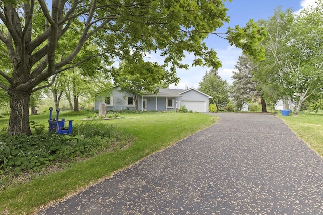 8530 N Kishwaukee Rd, Stillman Valley, IL 61084 - single story home featuring a front yard, a garage, and driveway