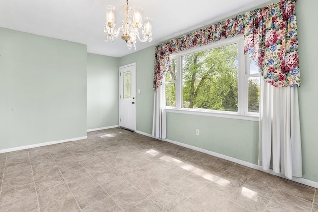 8530 N Kishwaukee Rd, Stillman Valley, IL 61084 - unfurnished room with a chandelier, baseboards, and tile patterned floors
