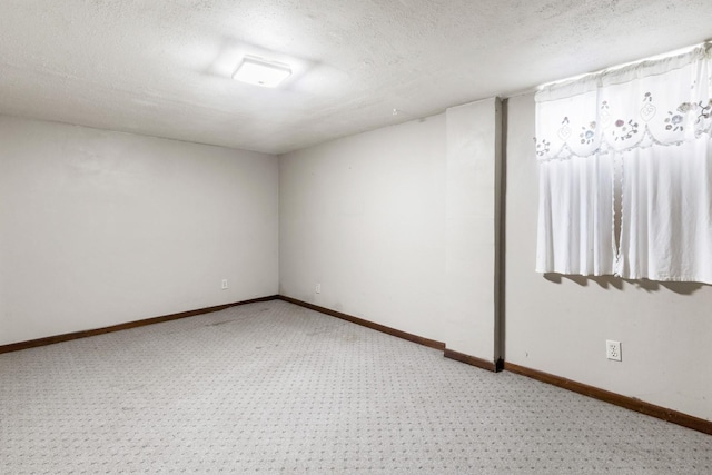 8530 N Kishwaukee Rd, Stillman Valley, IL 61084 - below grade area featuring light carpet, a textured ceiling, and baseboards