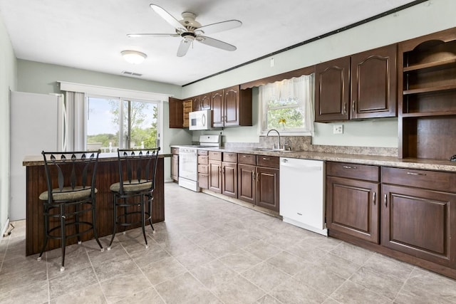 8530 N Kishwaukee Rd, Stillman Valley, IL 61084 - kitchen with white appliances, a sink, plenty of natural light, and a ceiling fan