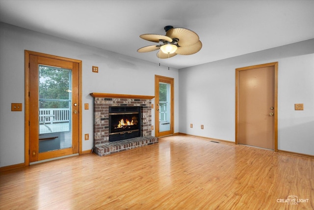 916 Shady Ln, Aurora, IL 60506 - unfurnished living room featuring wood finished floors, a fireplace, a ceiling fan, and baseboards