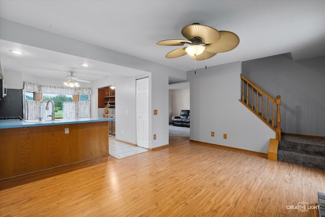 916 Shady Ln, Aurora, IL 60506 - unfurnished living room with ceiling fan, light wood finished floors, stairs, a sink, and recessed lighting