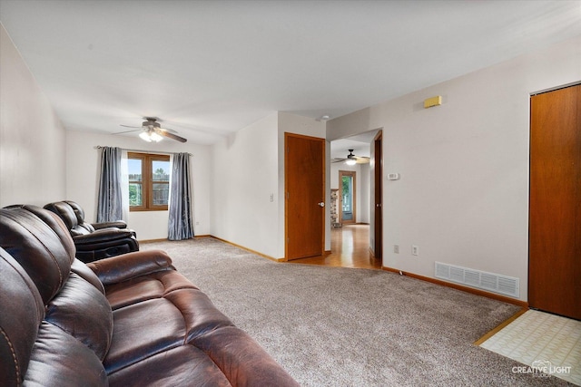 916 Shady Ln, Aurora, IL 60506 - living area featuring ceiling fan, light carpet, and baseboards