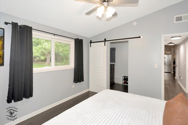 23246 S Malibu Dr, Manhattan, IL 60442 - bedroom featuring dark wood-type flooring, vaulted ceiling, baseboards, freestanding refrigerator, and a barn door