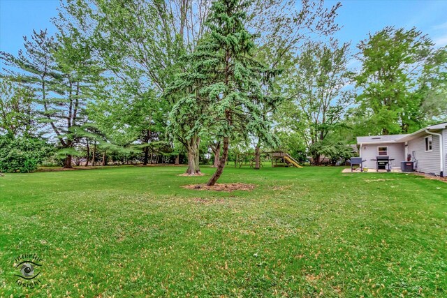 23246 S Malibu Dr, Manhattan, IL 60442 - view of grassy yard with a playground and view of scattered trees