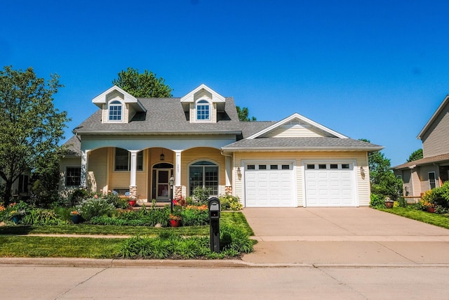3005 Wynstone Dr, Champaign, IL 61822 - view of front of house with an attached garage, a porch, driveway, and roof with shingles