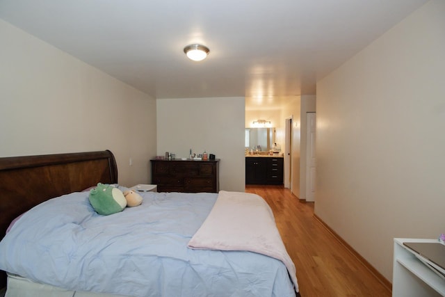 3150 W Bryn Mawr Ave Unit 301, Chicago, IL 60659 - bedroom with light wood-type flooring, connected bathroom, and baseboards