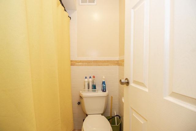 3150 W Bryn Mawr Ave Unit 301, Chicago, IL 60659 - bathroom featuring toilet, tile walls, and a wainscoted wall