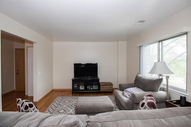 3150 W Bryn Mawr Ave Unit 301, Chicago, IL 60659 - living room featuring plenty of natural light, wood finished floors, and baseboards