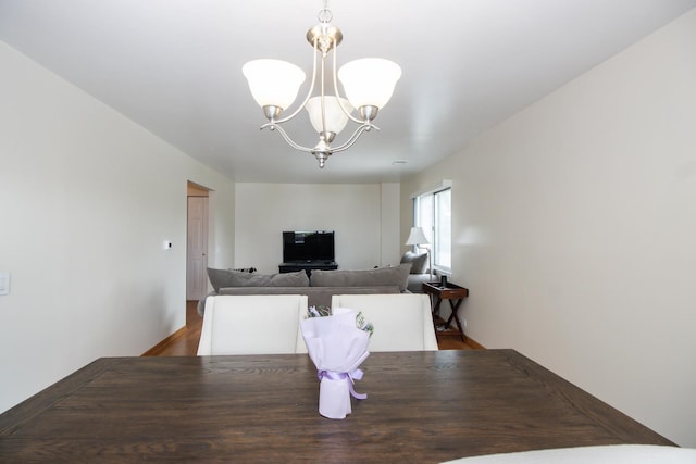 3150 W Bryn Mawr Ave Unit 301, Chicago, IL 60659 - dining room featuring a chandelier and wood finished floors