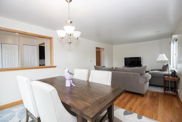 3150 W Bryn Mawr Ave Unit 301, Chicago, IL 60659 - dining space featuring a chandelier and light wood-style floors