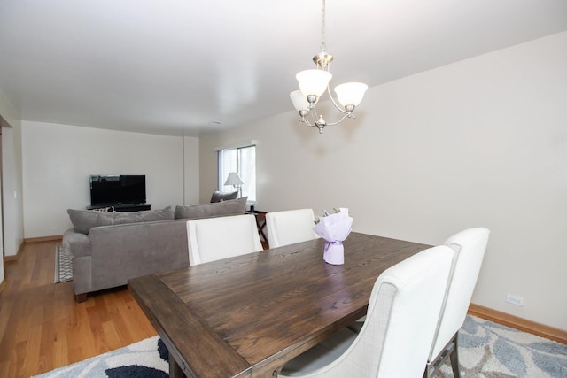3150 W Bryn Mawr Ave Unit 301, Chicago, IL 60659 - dining room featuring a chandelier, light wood-style floors, and baseboards