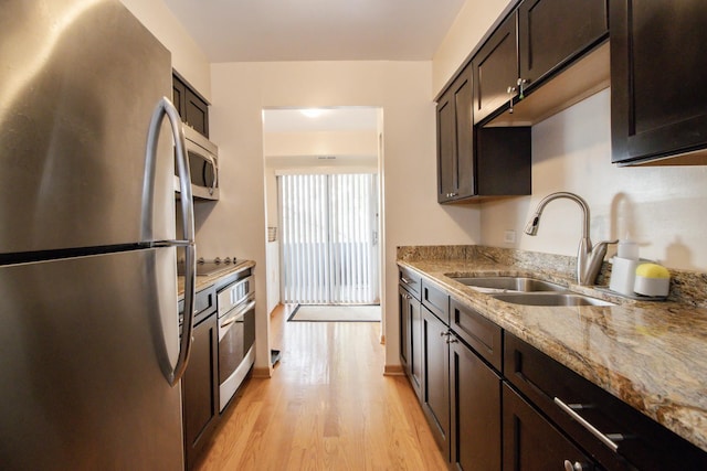 3150 W Bryn Mawr Ave Unit 301, Chicago, IL 60659 - kitchen with stainless steel appliances, a sink, dark brown cabinets, and light stone counters