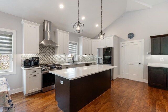 8029 98th St, Palos Hills, IL 60465 - kitchen with wall chimney range hood, appliances with stainless steel finishes, light countertops, a sink, and tasteful backsplash