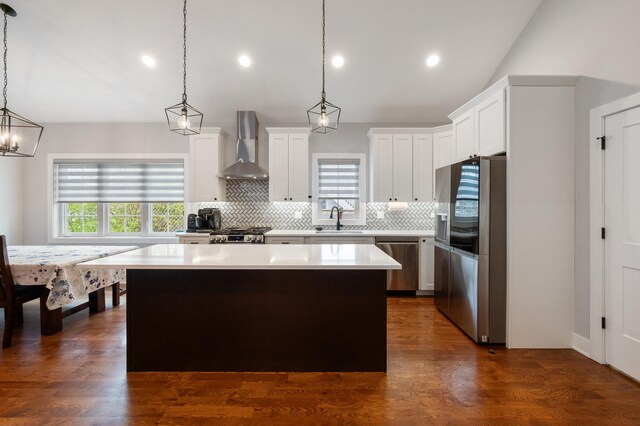 8029 98th St, Palos Hills, IL 60465 - kitchen featuring wall chimney exhaust hood, stainless steel appliances, a sink, a kitchen island, and lofted ceiling