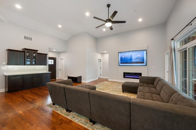 8029 98th St, Palos Hills, IL 60465 - living room with dark wood-type flooring, high vaulted ceiling, a ceiling fan, baseboards, and a glass covered fireplace