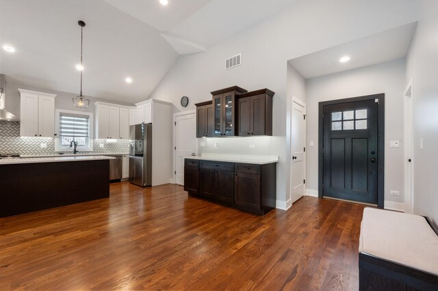 8029 98th St, Palos Hills, IL 60465 - kitchen featuring appliances with stainless steel finishes, a sink, light countertops, backsplash, and glass insert cabinets