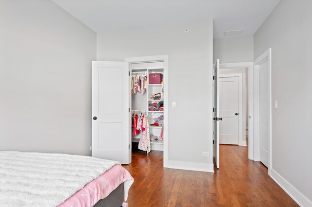 8029 98th St, Palos Hills, IL 60465 - bedroom with a walk in closet, a closet, wood finished floors, and baseboards
