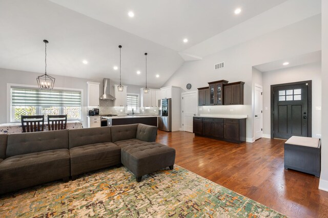 8029 98th St, Palos Hills, IL 60465 - living area with a chandelier, recessed lighting, dark wood-style flooring, healthy amount of natural light, and high vaulted ceiling