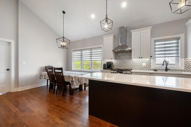 8029 98th St, Palos Hills, IL 60465 - kitchen with wall chimney exhaust hood, light countertops, decorative backsplash, a sink, and white cabinets