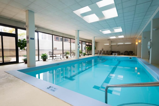 indoor pool featuring a skylight