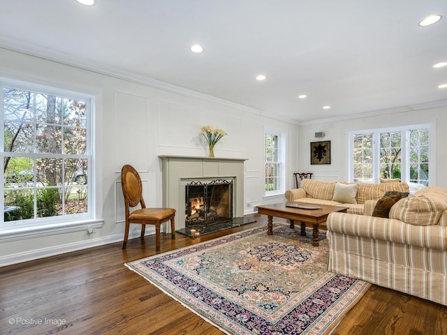110 Lakewood Pl, Highland Park, IL 60035 - living area with crown molding, dark wood finished floors, a decorative wall, recessed lighting, and a lit fireplace