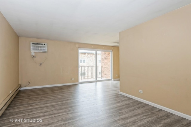 4137 W 97th Pl Unit 311, Oak Lawn, IL 60453 - spare room featuring baseboard heating, baseboards, wood finished floors, and an AC wall unit