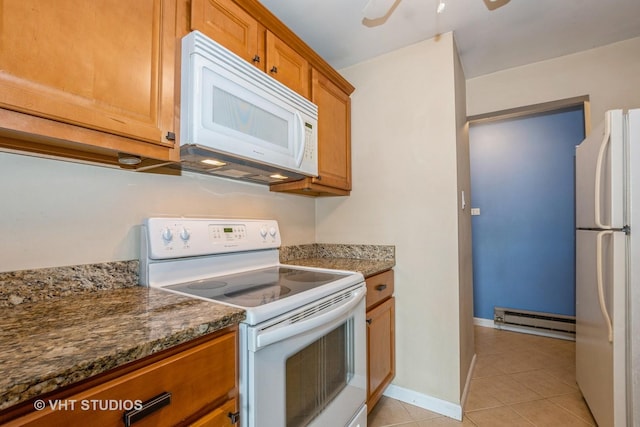 4137 W 97th Pl Unit 311, Oak Lawn, IL 60453 - kitchen with white appliances, a baseboard radiator, light tile patterned floors, brown cabinets, and dark stone countertops