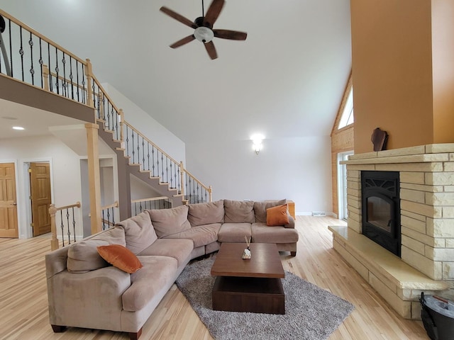 7648 N Indian Ridge Rd, East Dubuque, IL 61025 - living area featuring high vaulted ceiling, ceiling fan, wood finished floors, stairway, and baseboards