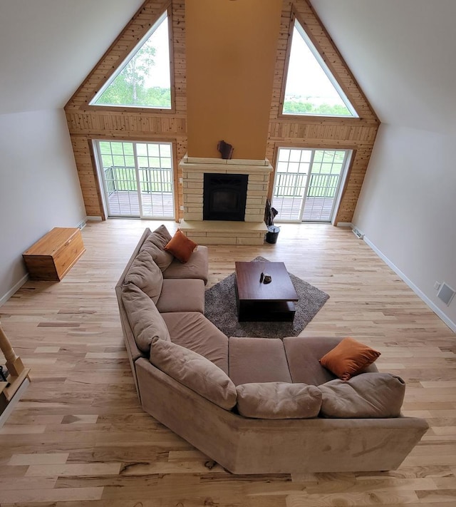 7648 N Indian Ridge Rd, East Dubuque, IL 61025 - living room with high vaulted ceiling, healthy amount of natural light, baseboards, and a stone fireplace