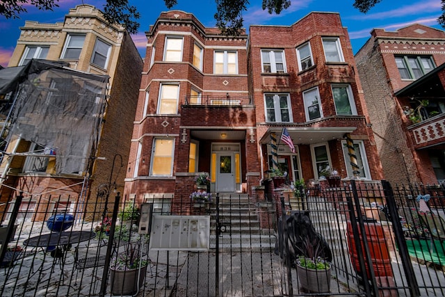 838 N Maplewood Ave Unit 1R, Chicago, IL 60622 - view of property with brick siding, a fenced front yard, and a gate