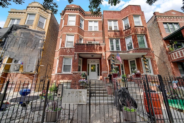 838 N Maplewood Ave Unit 1R, Chicago, IL 60622 - townhome / multi-family property featuring brick siding, a fenced front yard, and a gate